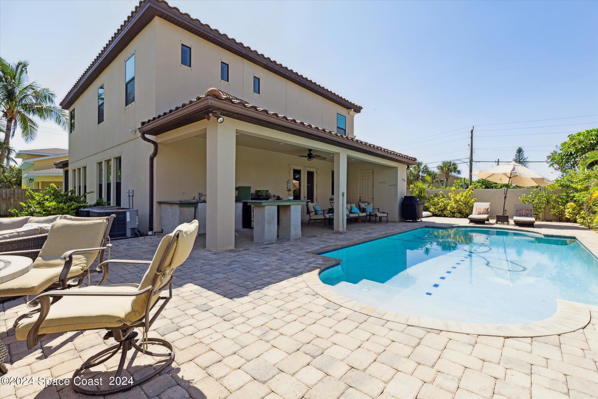 110 Poinsetta Street Indialantic, FL 32903 - Photo 51 of 67 a view of a house with backyard swimming pool and sitting area