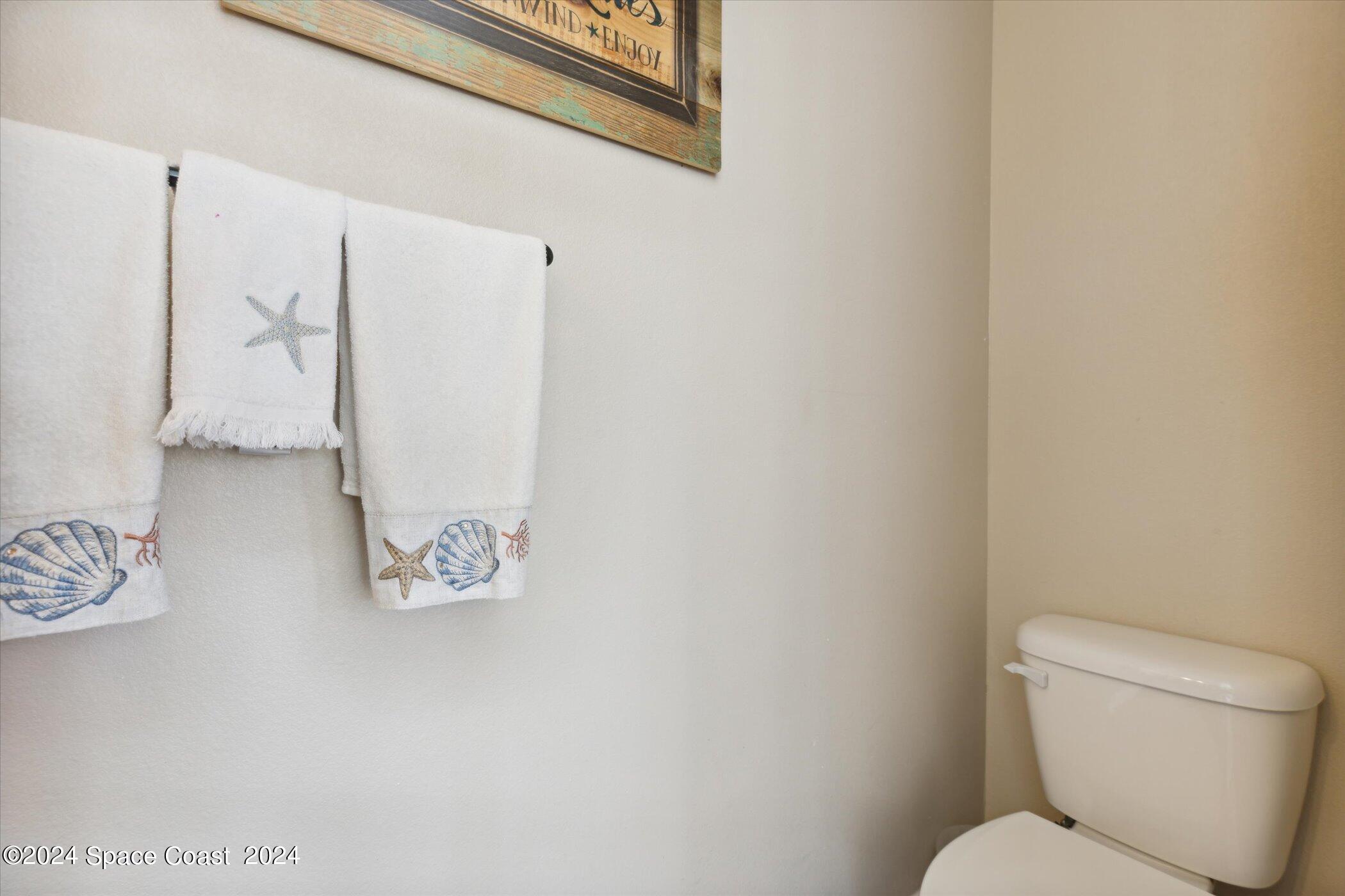 110 Poinsetta Street Indialantic, FL 32903 - Photo 55 of 67 a white toilet sitting next to a bathroom sink