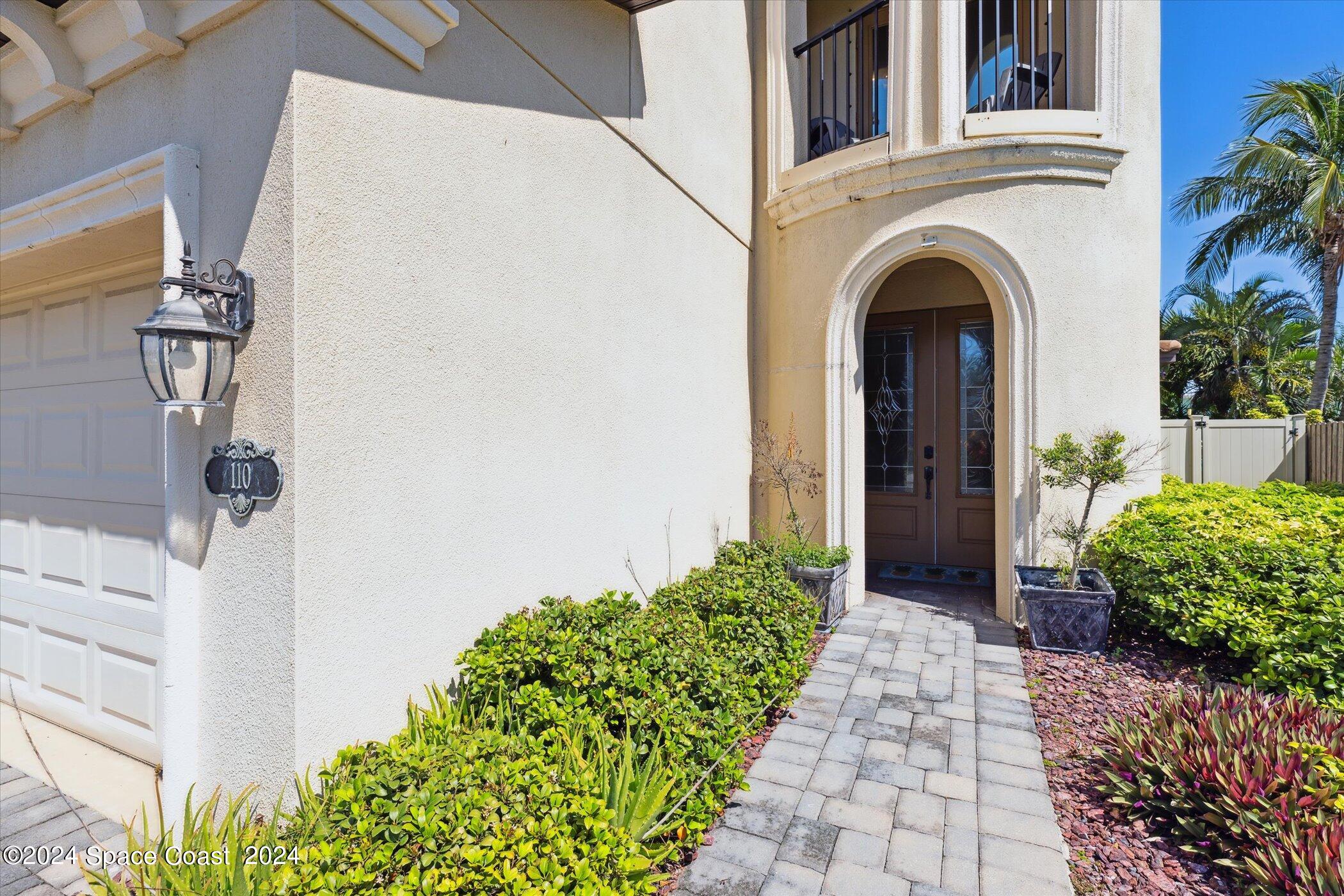 110 Poinsetta Street Indialantic, FL 32903 - Photo 6 of 67 a front view of a house with garden