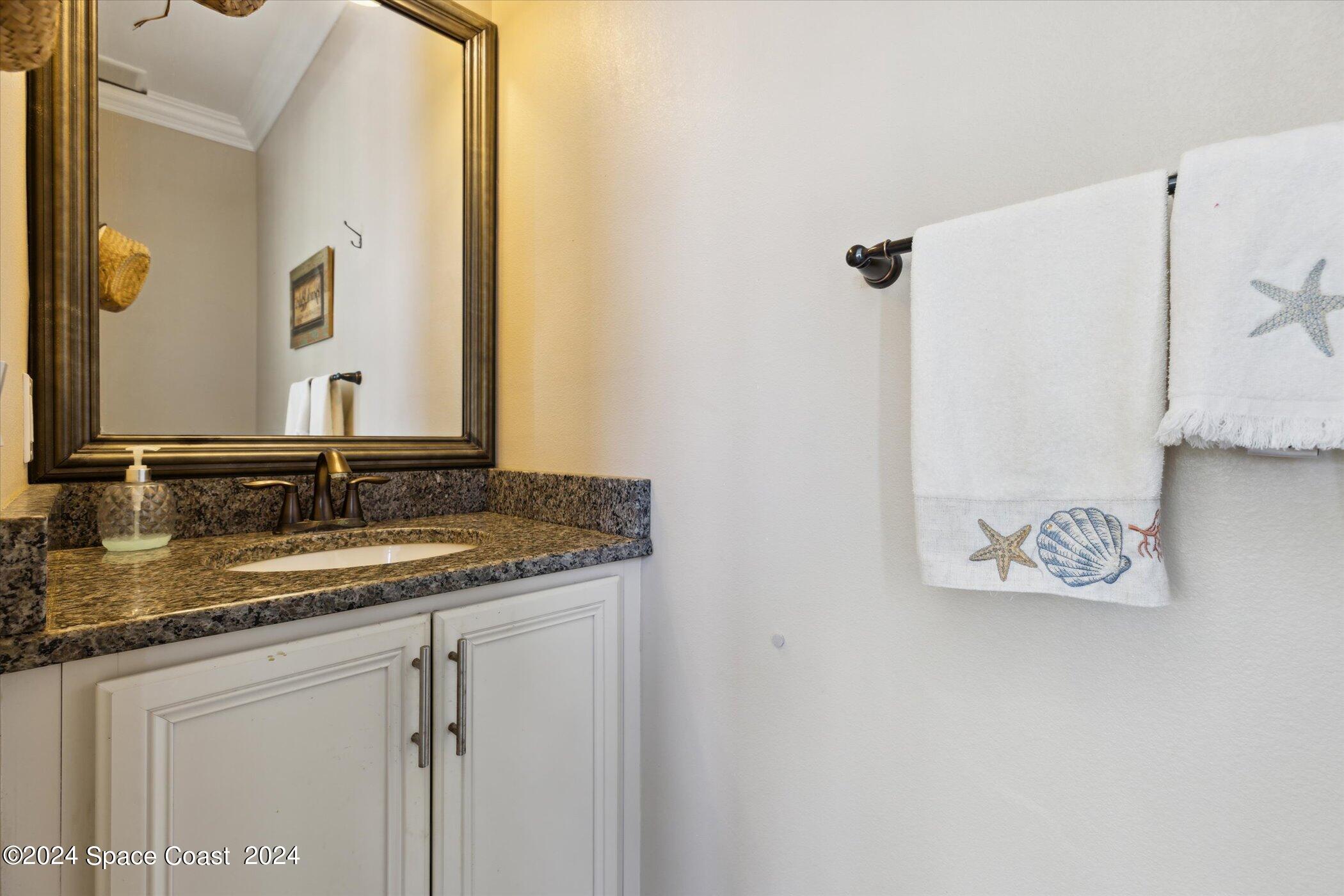 110 Poinsetta Street Indialantic, FL 32903 - Photo 64 of 67 a bathroom with a granite countertop sink and a mirror