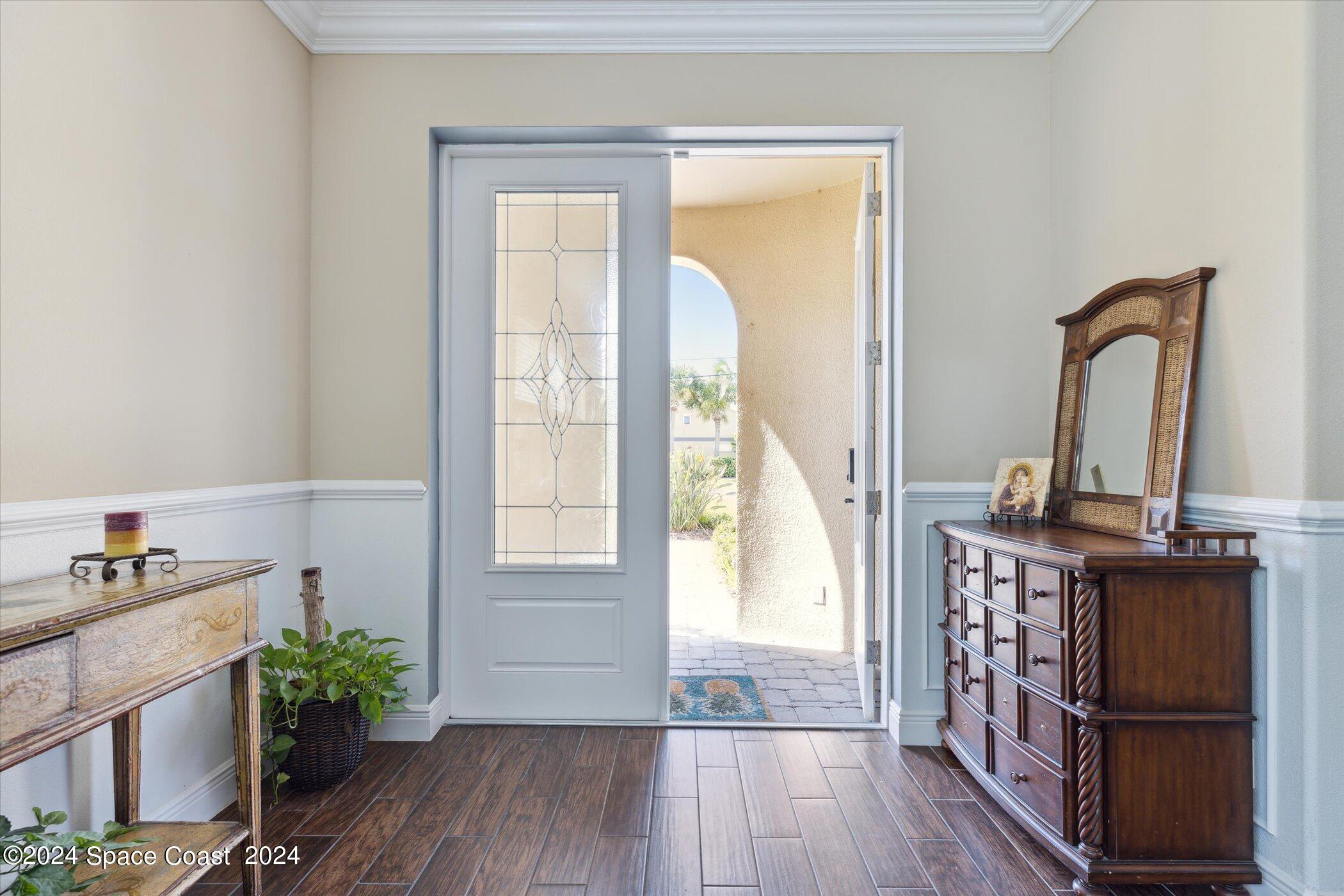 110 Poinsetta Street Indialantic, FL 32903 - Photo 8 of 67 a view of front door with hallway and wooden floor