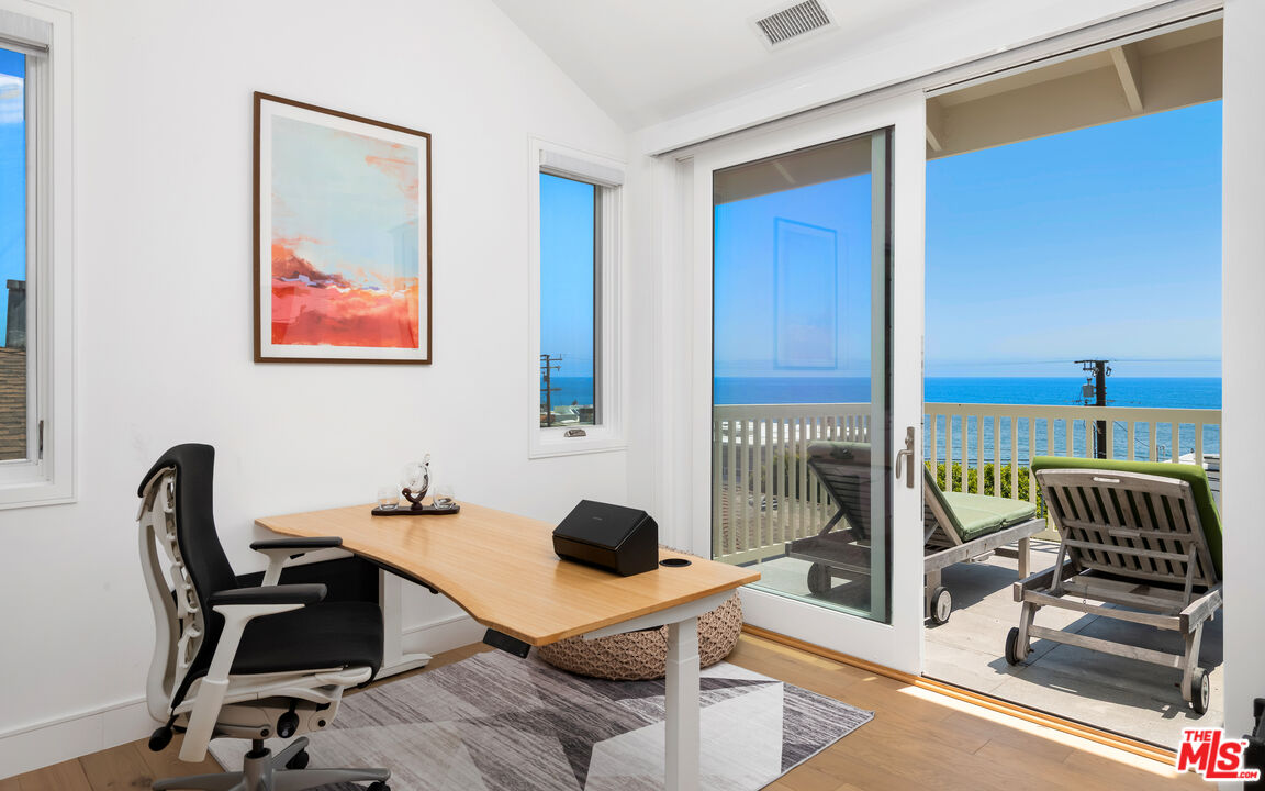 25157 Malibu Road Malibu, CA 90265 - Photo 18 of 33 a view of a workspace with furniture and floor to ceiling window