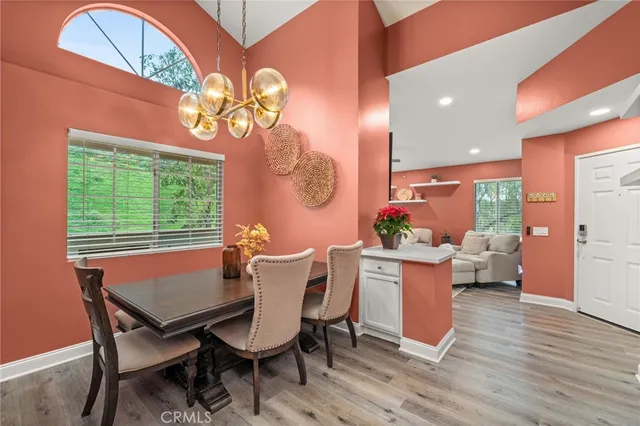 a dining room with furniture and wooden floor