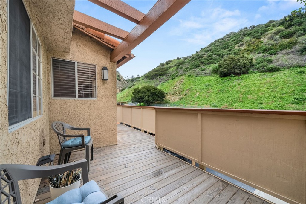 5470 Copper Canyon Road, Unit 2E Yorba Linda, CA 92887 - Photo 13 of 25 a view of a balcony with chair and wooden floor