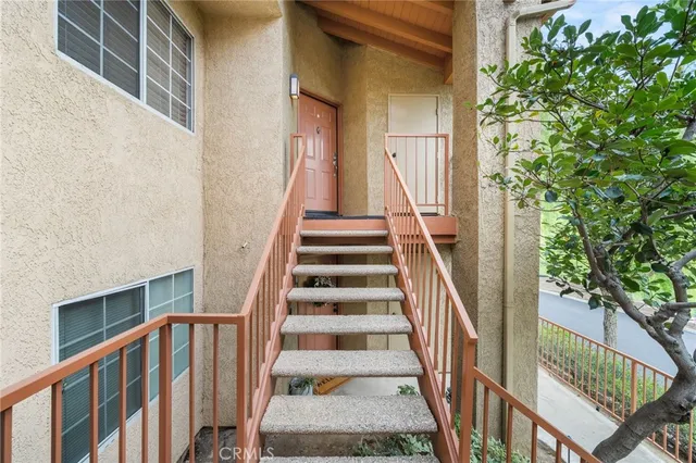 a view of staircase with wooden floor and a potted plant