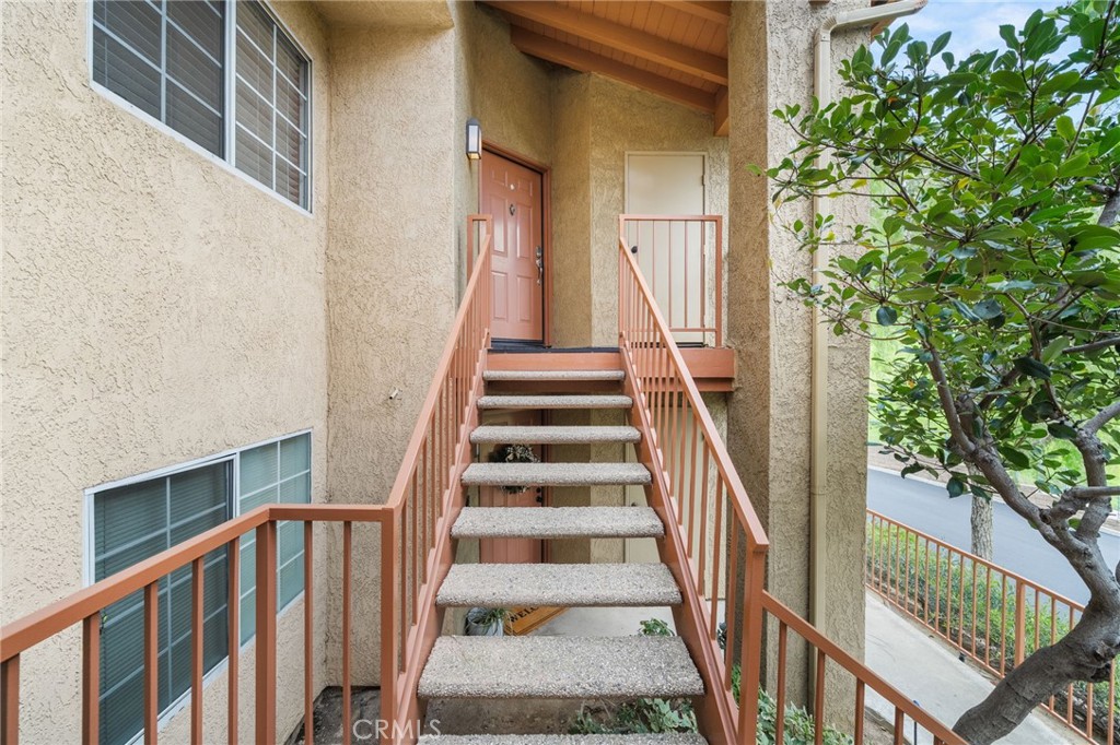 5470 Copper Canyon Road, Unit 2E Yorba Linda, CA 92887 - Photo 15 of 25 a view of staircase with wooden floor and a potted plant