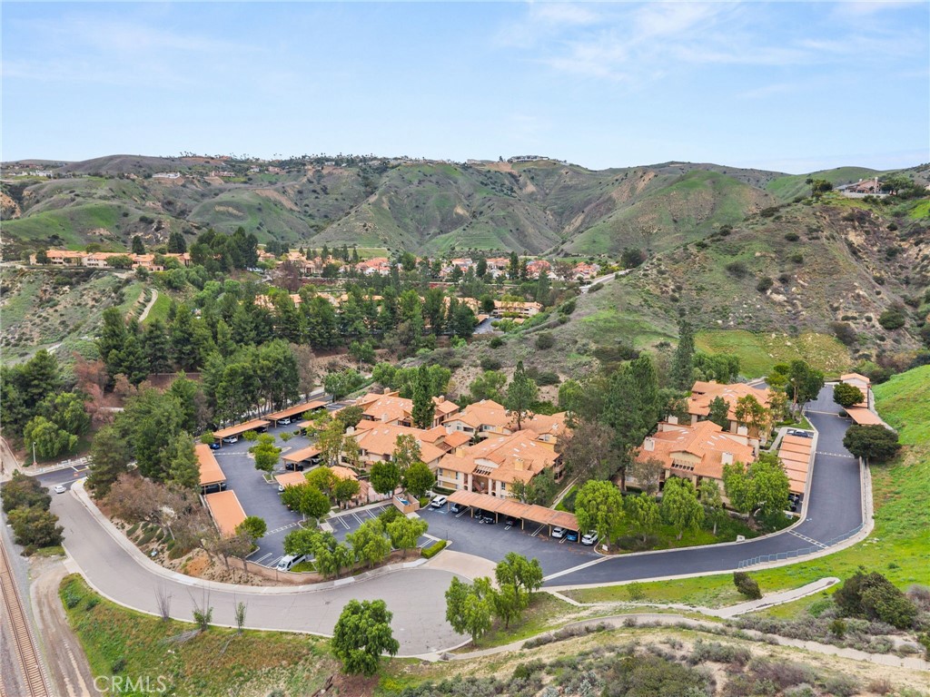 5470 Copper Canyon Road, Unit 2E Yorba Linda, CA 92887 - Photo 20 of 25 an aerial view of a house with a garden and lake view
