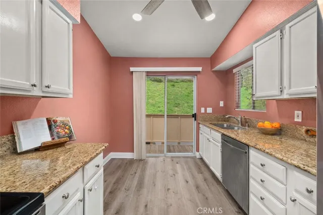 a kitchen with granite countertop a stove and a sink