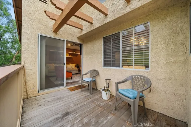 a balcony view with a dishwasher and a window