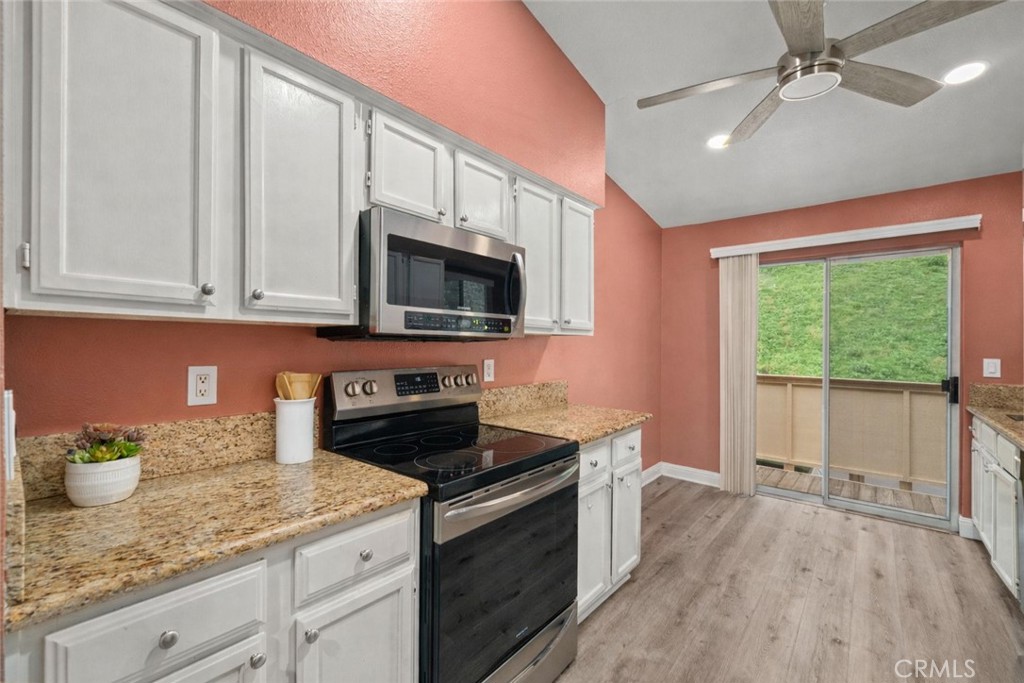 5470 Copper Canyon Road, Unit 2E Yorba Linda, CA 92887 - Photo 6 of 25 a kitchen with granite countertop a sink stainless steel appliances and cabinets