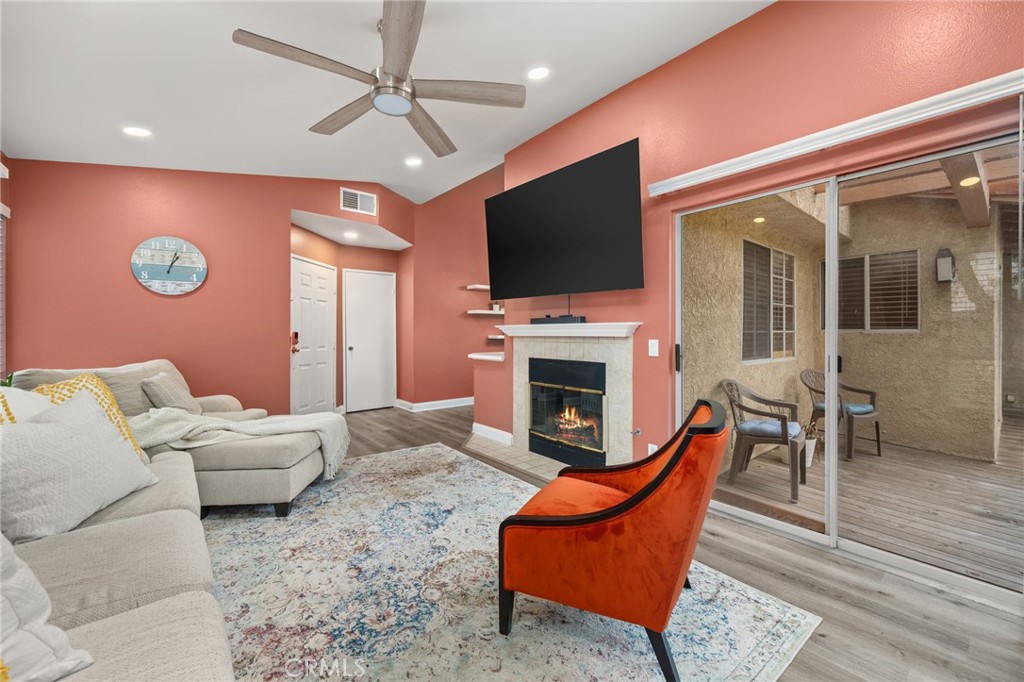 5470 Copper Canyon Road, Unit 2E Yorba Linda, CA 92887 - Photo 7 of 25 a living room with furniture a flat screen tv and a fireplace