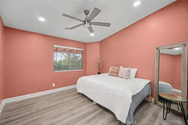 a bedroom with a large bed and a window