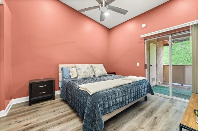 a bedroom with a bed window and a ceiling fan