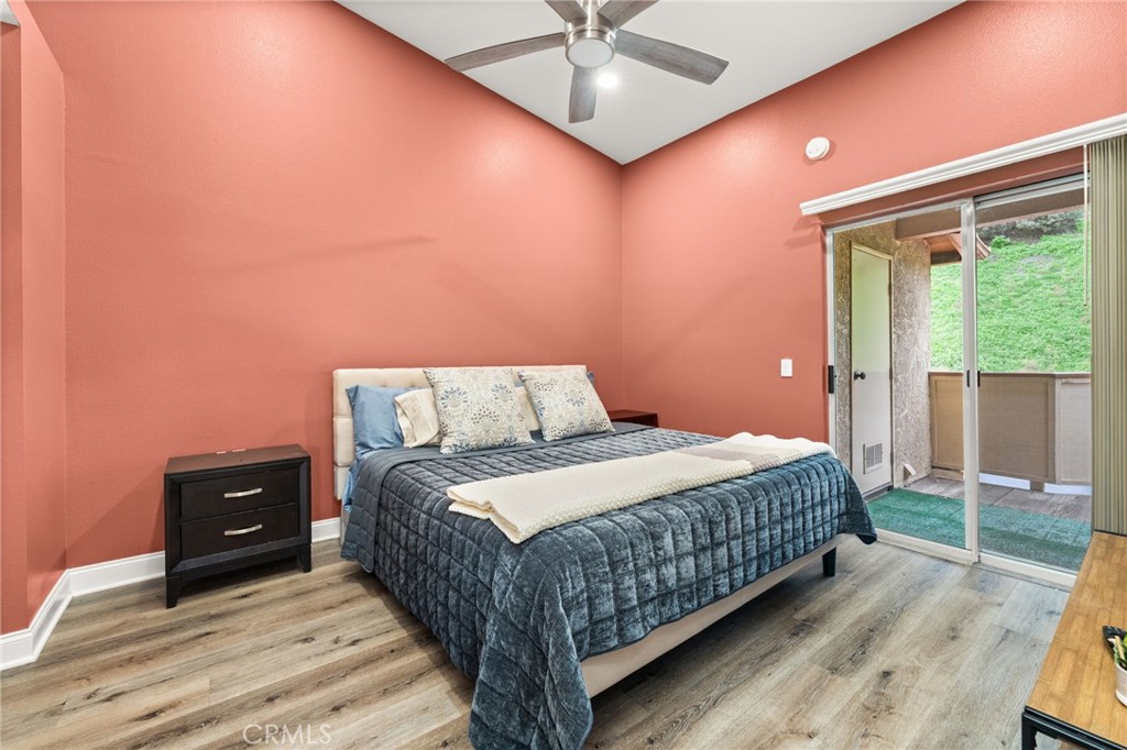 5470 Copper Canyon Road, Unit 2E Yorba Linda, CA 92887 - Photo 10 of 25 a bedroom with a bed window and a ceiling fan