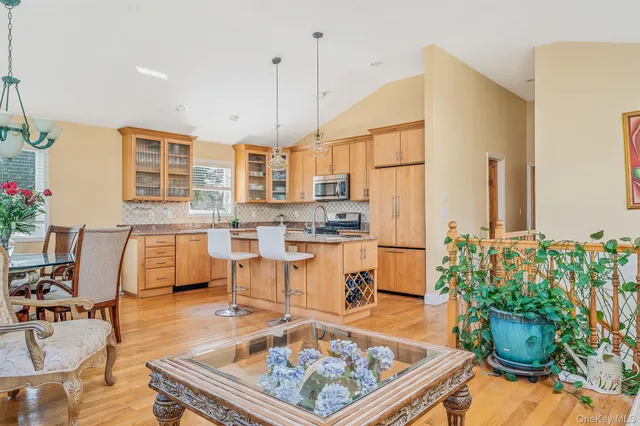 a kitchen with stainless steel appliances granite countertop a stove a sink and a refrigerator