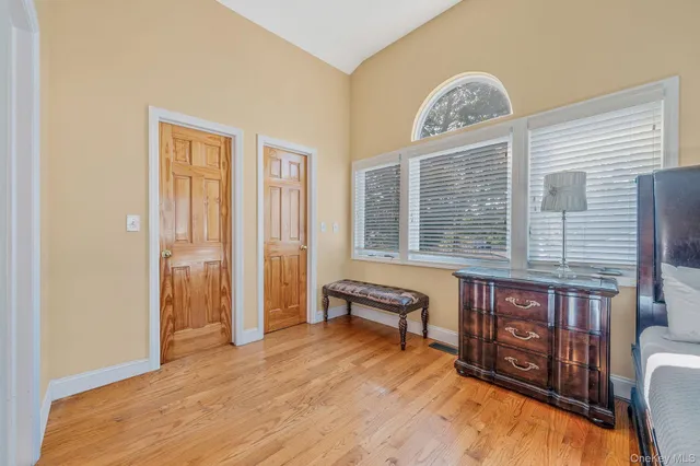 a view of a livingroom with furniture wooden floor and windows