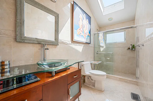 a bathroom with a granite countertop sink a toilet and a mirror