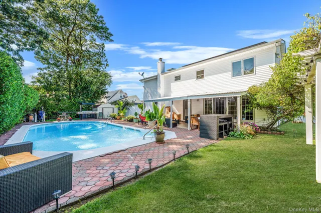 a view of a house with swimming pool and sitting area