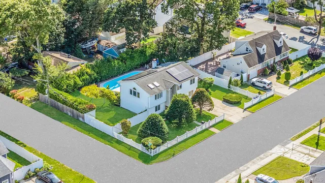 an aerial view of a house with a swimming pool