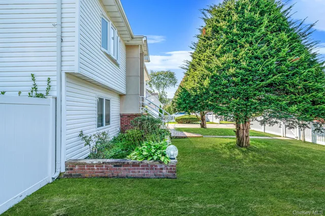a view of yard with small fountain plants and large trees