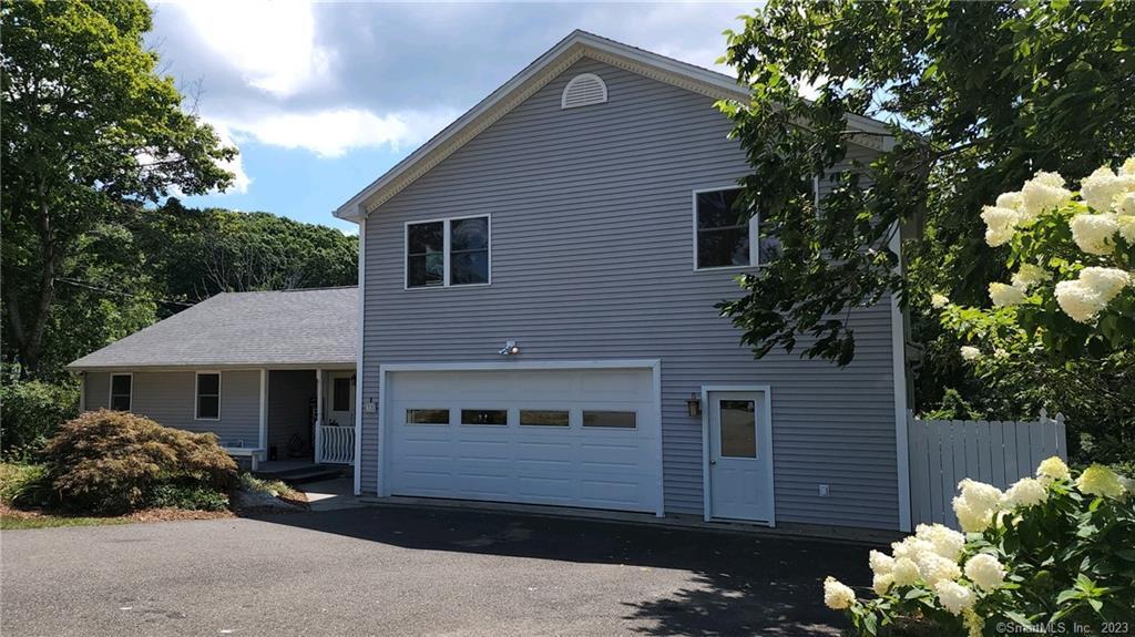 32 Benz Street Ansonia, CT 06401 - Photo 1 of 1 a front view of a house with a yard and garage