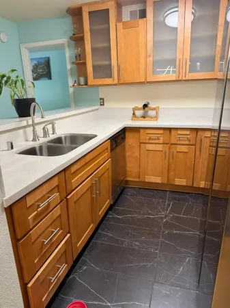 a kitchen with stainless steel appliances a sink stove and cabinets