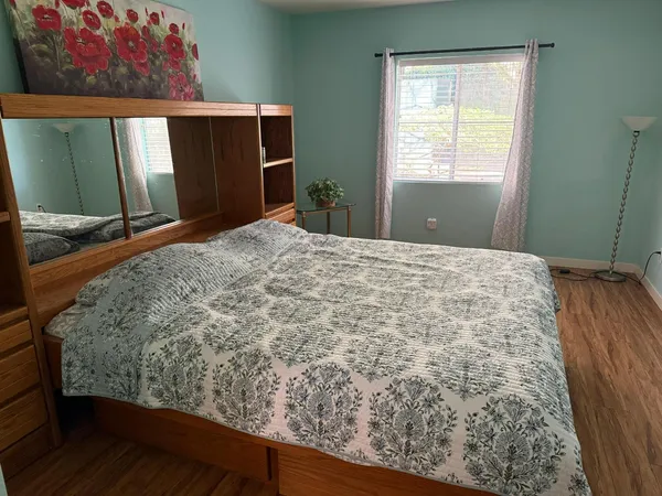 a bed sitting in a bedroom next to a window
