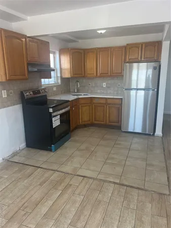 a kitchen with stainless steel appliances granite countertop a stove a sink and a refrigerator