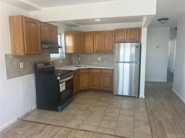 a kitchen with stainless steel appliances granite countertop a refrigerator sink and cabinets
