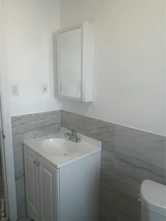 a bathroom with a sink toilet and vanity