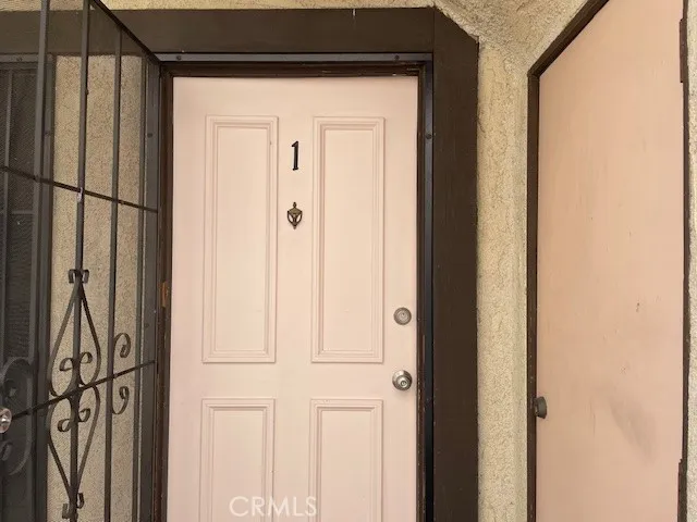 a view of empty room with kitchen and fireplace