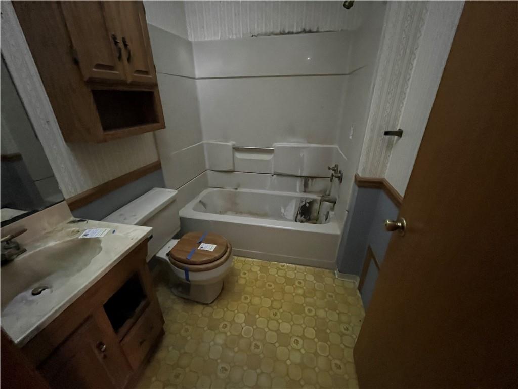 825 San Spur Road Du Bois, PA 15801 - Photo 11 of 15 a bathroom with a granite countertop toilet a sink and a mirror