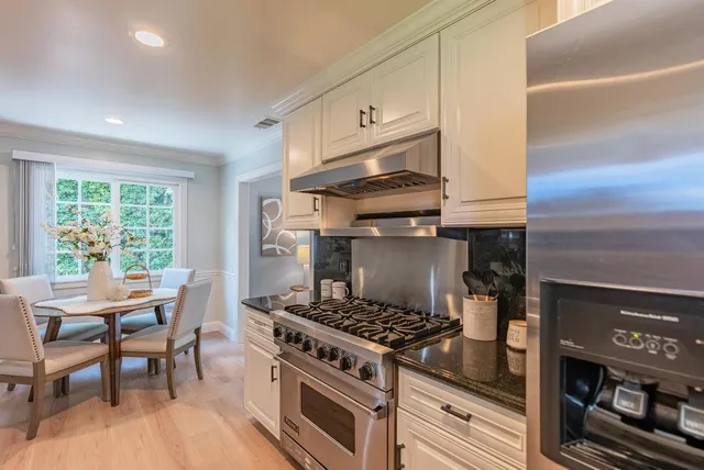 a kitchen with a stove a sink and a table
