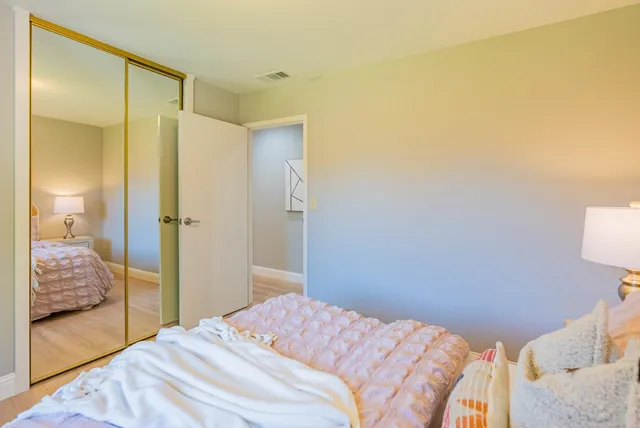 a bedroom with a bed and a walk in closet