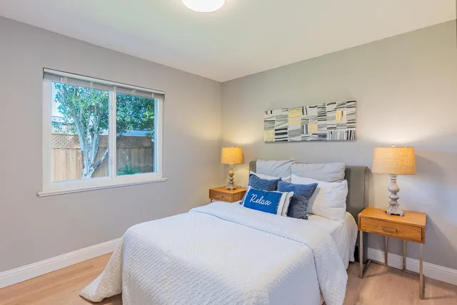 a bed room with a bed and a lamp