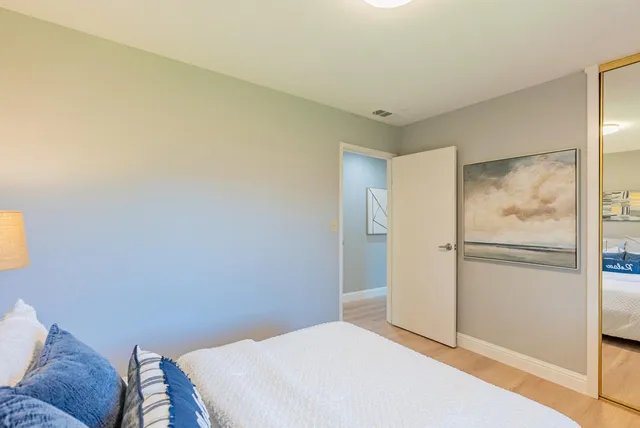 a bedroom with a bed and a rug