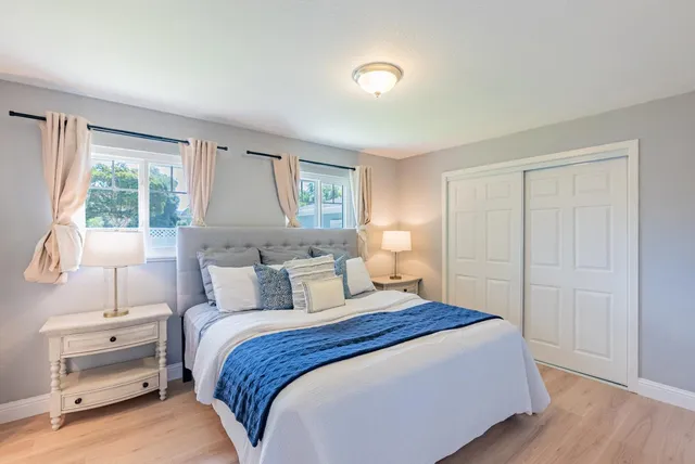 a bedroom with a bed and a night stand