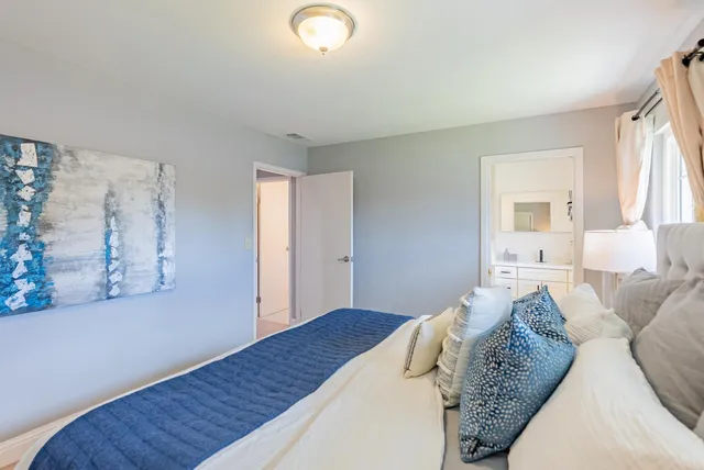 a bedroom with a large bed and a window