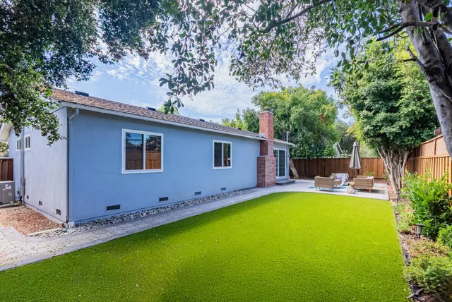 a view of a house with a backyard and a patio