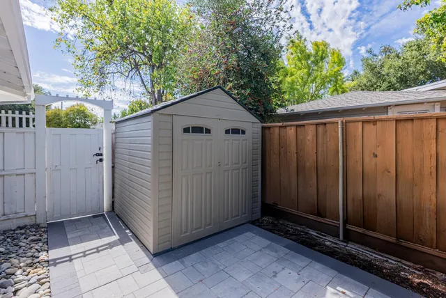 a view of backyard with plants and trees