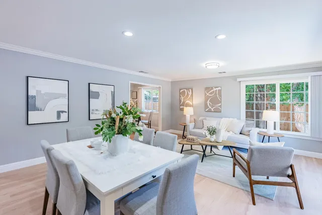 a view of a dining room with furniture window and wooden floor