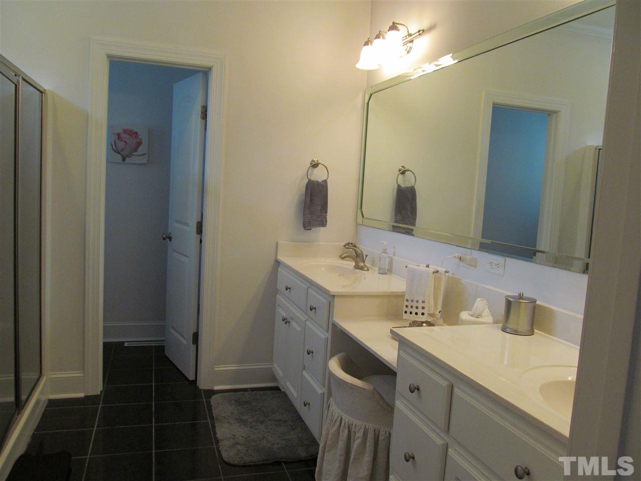 3540 Saddle Ridge Road Stem, NC 27581 - Photo 14 of 25 a bathroom with a sink and a mirror