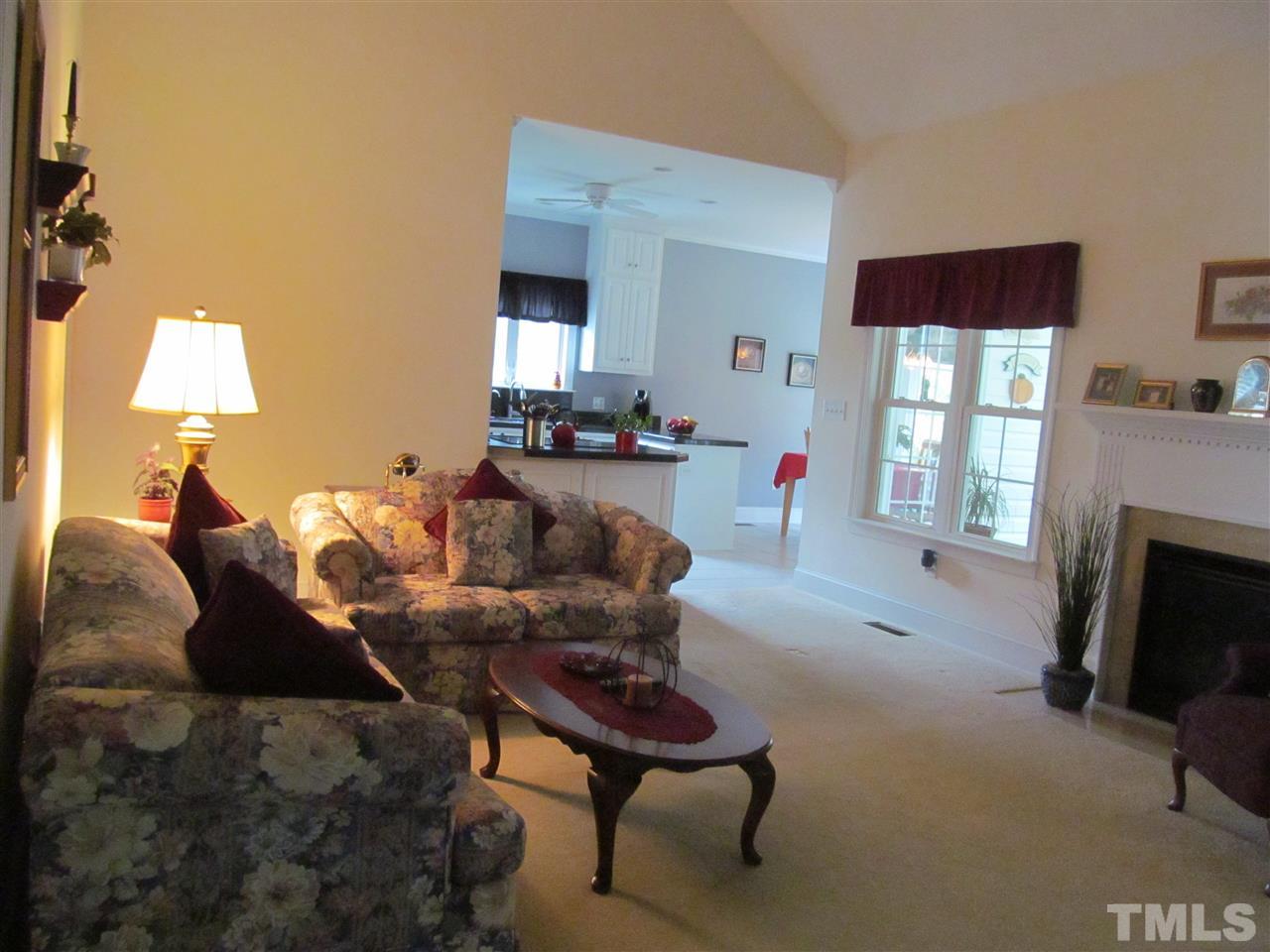 3540 Saddle Ridge Road Stem, NC 27581 - Photo 7 of 25 a living room with furniture a fireplace and a flat screen tv