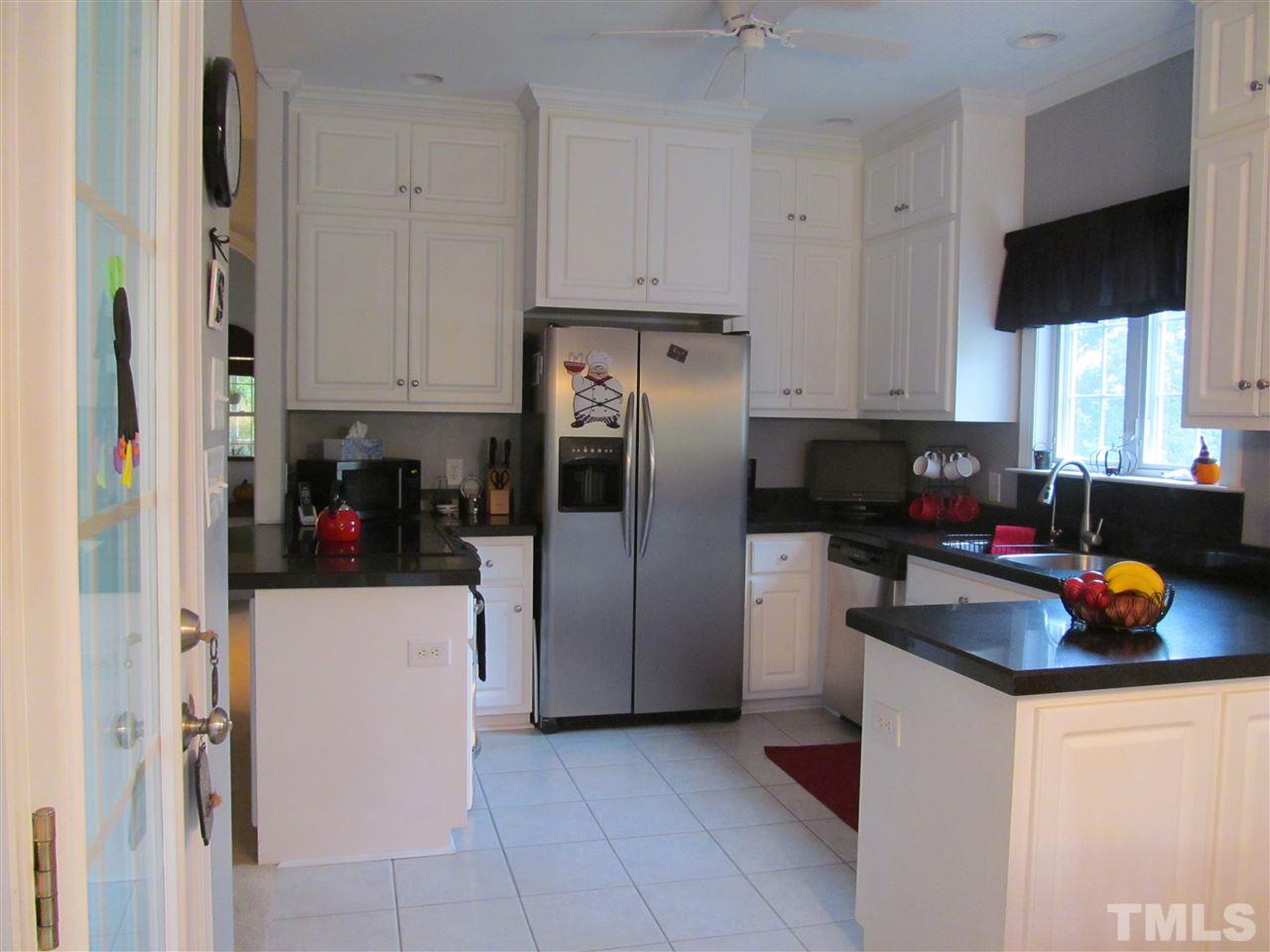 3540 Saddle Ridge Road Stem, NC 27581 - Photo 9 of 25 a kitchen with stainless steel appliances a refrigerator a sink a stove and cabinets