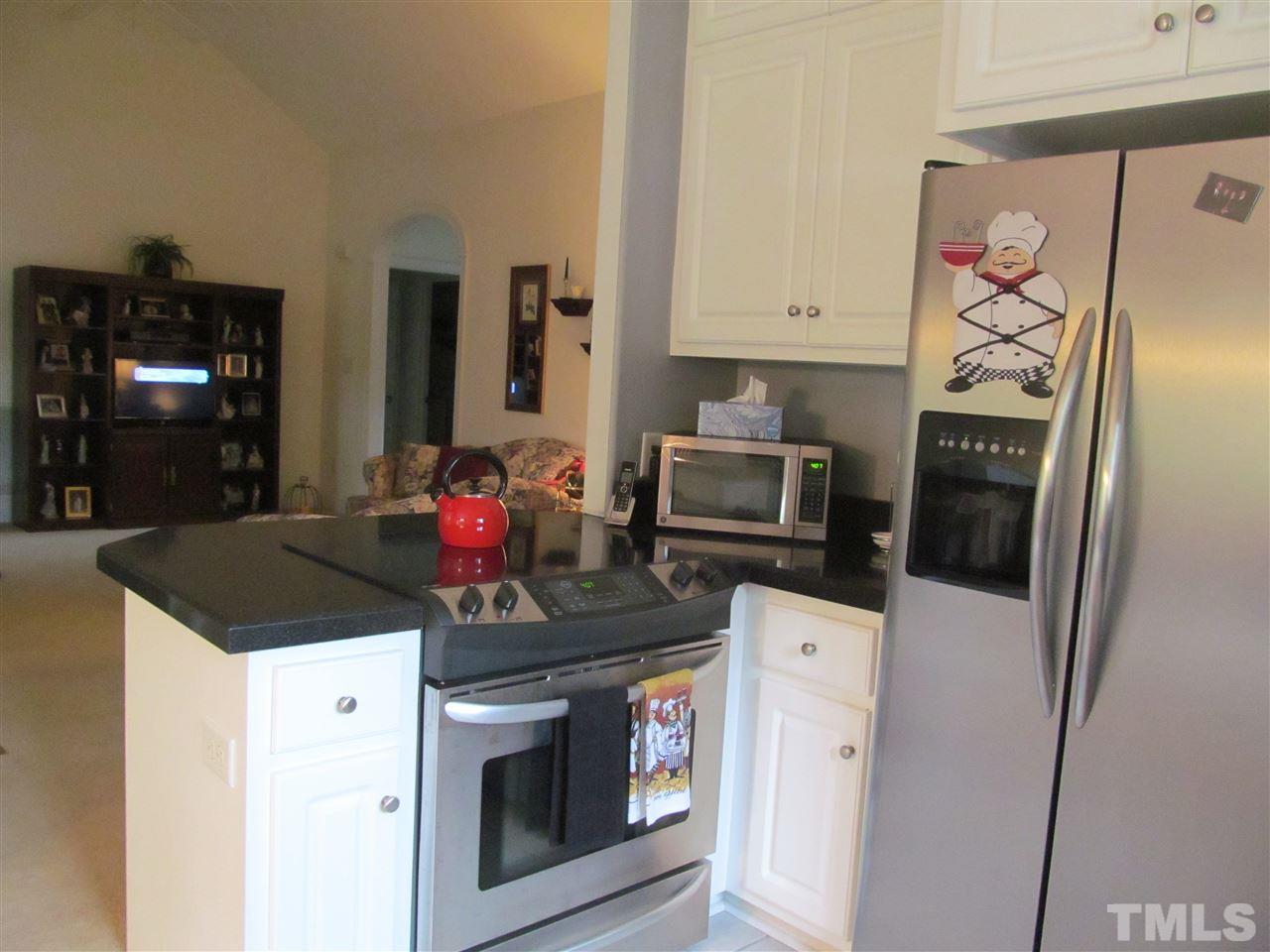 3540 Saddle Ridge Road Stem, NC 27581 - Photo 10 of 25 a kitchen with stainless steel appliances a stove microwave and refrigerator
