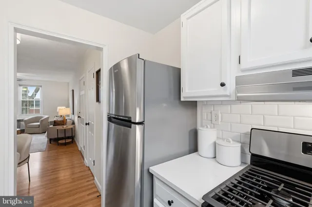 a kitchen with a refrigerator and a stove