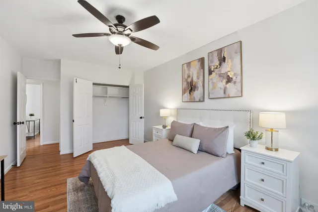 a bedroom with a bed and a potted plant