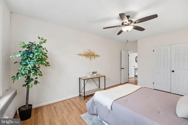 a bedroom with a large bed a chandelier and a window