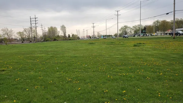 a view of a big yard with a city view