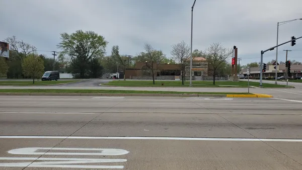 a view of a field of grass and trees